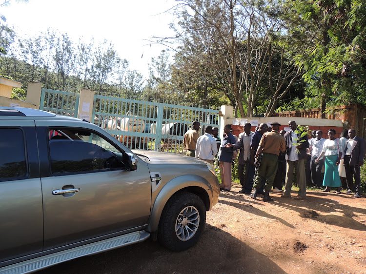 A section of Migori county government workers stand their ground as they argue with armed APs at the county water and energy department during a past industrial action.COURTESY